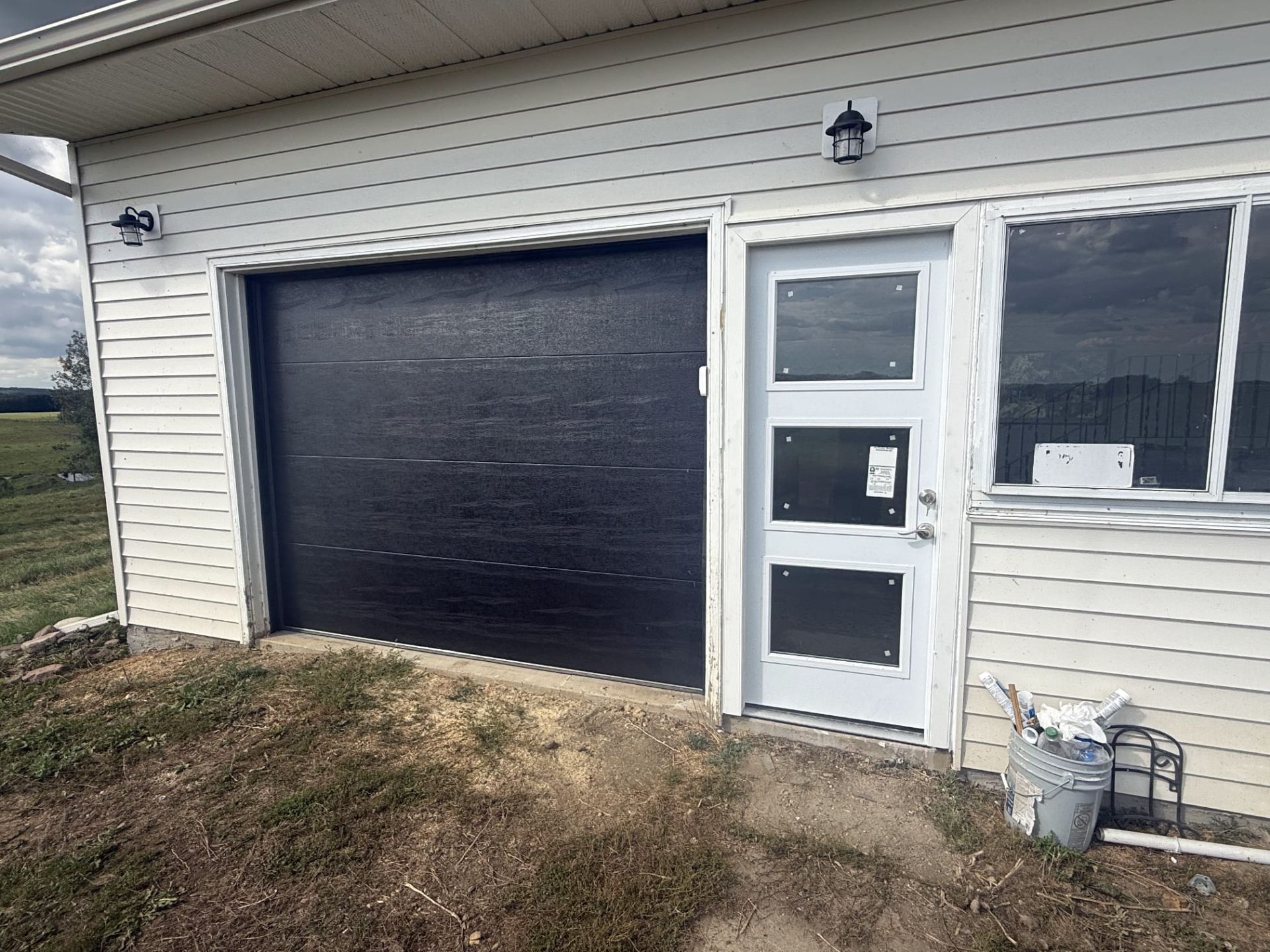 Custom man door installed next to garage door